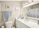 Bright bathroom featuring a white vanity, framed mirror, and updated lighting fixtures at 2022 Heathfield Cir, Sun City Center, FL 33573