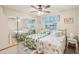 Cozy bedroom with mirrored closet doors, a ceiling fan, and coastal-themed decor at 2022 Heathfield Cir, Sun City Center, FL 33573