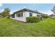 A well-maintained single-story home shows a lush green lawn and a glimpse of the screened-in lanai at 2022 Heathfield Cir, Sun City Center, FL 33573