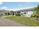 Well-maintained single-story home featuring a manicured lawn and lush landscaping at 2022 Heathfield Cir, Sun City Center, FL 33573
