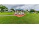 A gazebo and a Little Free Library in a well-maintained grassy area of a community at 2022 Heathfield Cir, Sun City Center, FL 33573