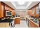Efficient kitchen offers ample counter space, wood cabinets, and stainless steel appliances at 2022 Heathfield Cir, Sun City Center, FL 33573