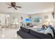 Cozy living room with tile flooring, ceiling fan, comfortable seating, and lots of natural light at 2022 Heathfield Cir, Sun City Center, FL 33573