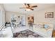 Inviting living room features tile flooring, a ceiling fan, and comfortable seating for a relaxing atmosphere at 2022 Heathfield Cir, Sun City Center, FL 33573
