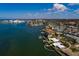 A scenic aerial view highlights this waterfront property's desirable location, mature trees and private pier at 2240 Harbor View Dr, Dunedin, FL 34698