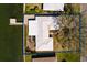 Aerial view of property with private pier, lush landscaping and waterfront access at 2240 Harbor View Dr, Dunedin, FL 34698