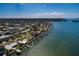Stunning aerial view of waterfront home with boat dock and bay access in a desirable neighborhood at 2240 Harbor View Dr, Dunedin, FL 34698