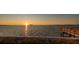 Stunning sunset view from the dock, overlooking the tranquil waters and distant horizon at 2240 Harbor View Dr, Dunedin, FL 34698