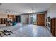 An empty living room with tile floors and sliding glass doors to the outside at 2240 Harbor View Dr, Dunedin, FL 34698