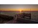 A view of a wooden pier with a sunset in the background at 2240 Harbor View Dr, Dunedin, FL 34698