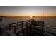 Wooden pier extending into the water at sunset at 2240 Harbor View Dr, Dunedin, FL 34698