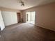 Bedroom featuring natural light from the sliding glass doors and closet with white doors at 2449 Columbia Dr # 29, Clearwater, FL 33763