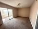 Bedroom showcasing natural light from the glass sliding doors and neutral walls and carpet at 2449 Columbia Dr # 29, Clearwater, FL 33763