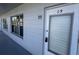 Exterior view of unit's front door and window, showcasing well-kept building facade at 2449 Columbia Dr # 29, Clearwater, FL 33763