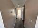 Hallway with neutral walls and carpet flooring, leading to other rooms in the home at 2449 Columbia Dr # 29, Clearwater, FL 33763