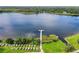 Picturesque lake view featuring a wooden dock and colorful kayaks on the grassy shore at 2449 Columbia Dr # 29, Clearwater, FL 33763