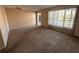 Bright living room with large windows, neutral walls, and comfortable carpet flooring at 2449 Columbia Dr # 29, Clearwater, FL 33763