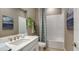 Bright bathroom with a tub and shower combination, a vanity with a white countertop, and neutral wall decor at 29444 Toricelli Rd, Wesley Chapel, FL 33543