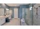 Stylish bathroom features dual vanities, a frameless glass shower, elegant fixtures, and designer finishes at 29444 Toricelli Rd, Wesley Chapel, FL 33543