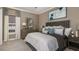 Bedroom with king size bed, blue accents, carpet, dresser and bedside tables at 29444 Toricelli Rd, Wesley Chapel, FL 33543