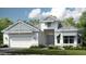 Charming single-Gathering home showcases a manicured lawn, a two-car garage, and classic architectural detailing at 29444 Toricelli Rd, Wesley Chapel, FL 33543