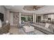 Cozy living room with a large sectional sofa, modern decor, and a seamless transition to the outdoor pool area at 29444 Toricelli Rd, Wesley Chapel, FL 33543