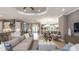 Open concept living room, dining room and kitchen with white cabinets and modern decor at 29444 Toricelli Rd, Wesley Chapel, FL 33543