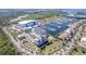 An aerial view of a coastal community with a marina, condos, houses, service building, and landscaping at 3025 Bermuda Sloop Cir, Ruskin, FL 33570