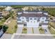 Captivating aerial view of a three-story townhome complex with lush landscaping, water views, and private garages at 3025 Bermuda Sloop Cir, Ruskin, FL 33570