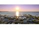 Stunning aerial view of a waterfront restaurant as the sun sets on the horizon at 3025 Bermuda Sloop Cir, Ruskin, FL 33570