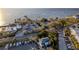 An aerial shot offers a view of parking, tennis courts, palm trees, and waterfront in the distance at 3025 Bermuda Sloop Cir, Ruskin, FL 33570