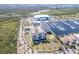An aerial image shows a coastal community with condos, a marina, homes, and a service building at 3025 Bermuda Sloop Cir, Ruskin, FL 33570