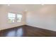 Empty bedroom features light walls, dark floors, and windows at 3025 Bermuda Sloop Cir, Ruskin, FL 33570