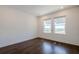 This bright bedroom features hardwood floors and a pair of windows offering beautiful views at 3025 Bermuda Sloop Cir, Ruskin, FL 33570