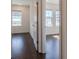 Bright bedroom featuring hardwood floors, white walls, and natural light from two large windows at 3025 Bermuda Sloop Cir, Ruskin, FL 33570