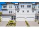 Beautiful three-story townhome features attached garages, well-maintained landscaping, and a contemporary design at 3025 Bermuda Sloop Cir, Ruskin, FL 33570