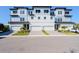 Contemporary three-story townhome boasts attached garages and attractive landscaping at 3025 Bermuda Sloop Cir, Ruskin, FL 33570