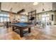 Stylish game room with a pool table, poker table, and comfortable seating areas for entertainment at 3025 Bermuda Sloop Cir, Ruskin, FL 33570