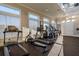 Bright gym with fitness equipment, including treadmills, rowing machines, and large windows for natural light at 3025 Bermuda Sloop Cir, Ruskin, FL 33570
