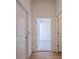 Bright hallway offering access to several rooms, featuring wood-look tile floors at 3025 Bermuda Sloop Cir, Ruskin, FL 33570