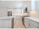 Modern, bright kitchen featuring stainless steel appliances, white countertops, and a central island with sink at 3025 Bermuda Sloop Cir, Ruskin, FL 33570