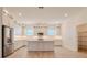 Modern kitchen features sleek stainless steel appliances, white cabinetry, and a functional island at 3025 Bermuda Sloop Cir, Ruskin, FL 33570