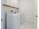 Bright laundry room with new washer and dryer, complemented by ample cabinet space at 3025 Bermuda Sloop Cir, Ruskin, FL 33570