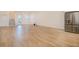 Spacious living room featuring new wood-style tile flooring and stainless steel refrigerator at 3025 Bermuda Sloop Cir, Ruskin, FL 33570