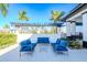 Outdoor lounge area with stylish blue seating offers a serene space for relaxation and gatherings at 3025 Bermuda Sloop Cir, Ruskin, FL 33570