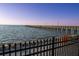 Beautiful waterfront featuring a long pier with evenly spaced lights and clear water at 3025 Bermuda Sloop Cir, Ruskin, FL 33570