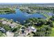 Beautiful aerial view of the home surrounded by lush greenery and a tranquil lake at 310 Manns Harbor Dr, Apollo Beach, FL 33572