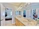 Bathroom with double vanity sinks, soaking tub and walk-in closet at 310 Manns Harbor Dr, Apollo Beach, FL 33572