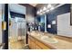 Elegant bathroom features a double vanity with a large mirror, stylish fixtures, and a shower-tub combo at 310 Manns Harbor Dr, Apollo Beach, FL 33572
