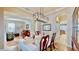 Open-concept dining area features an elegant chandelier, with views of the living room and hallway at 310 Manns Harbor Dr, Apollo Beach, FL 33572